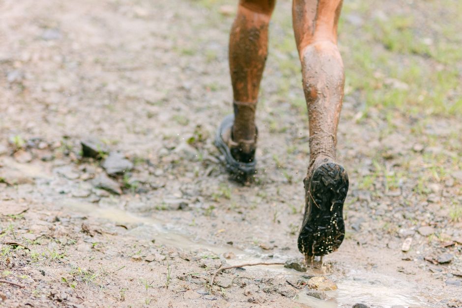 Runner's shoes on an Idaho trail representing Achilles tendon activity and recovery