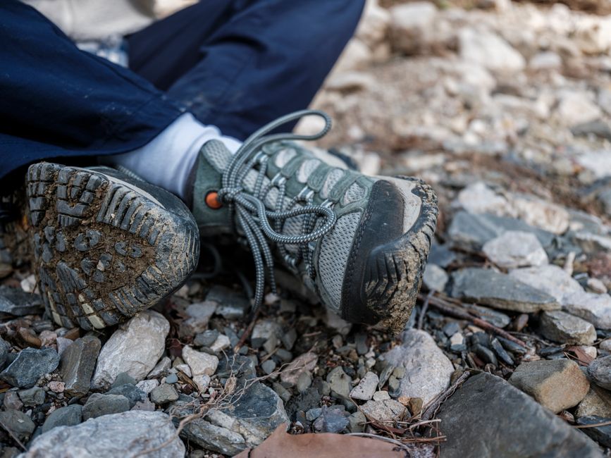 Hiking boots on a foothills trail, representing an active life without big toe pain